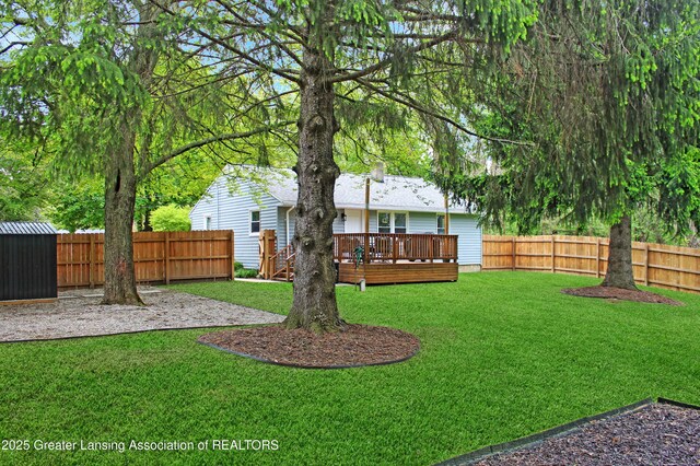14275 Webster Rd, Bath, MI 48808 - view of yard featuring a wooden deck, an outbuilding, and a storage shed