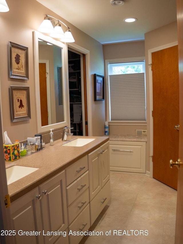 1561 Roseland Ave, East Lansing, MI 48823 - bathroom featuring double vanity, tile patterned flooring, and recessed lighting