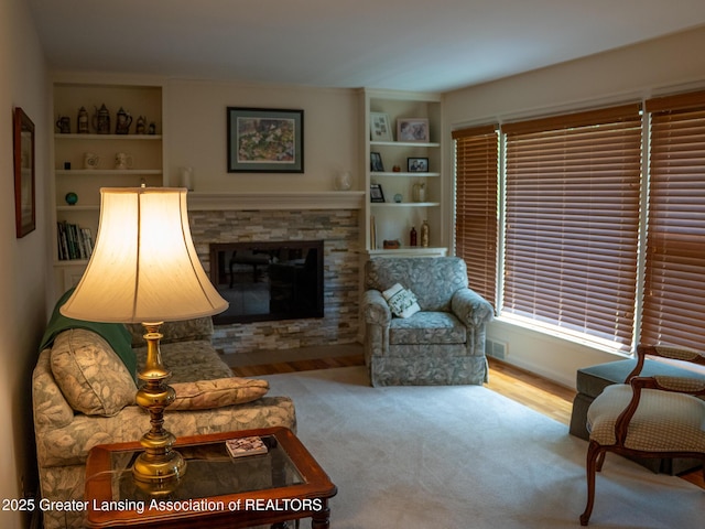 1561 Roseland Ave, East Lansing, MI 48823 - carpeted living area with built in shelves and a fireplace