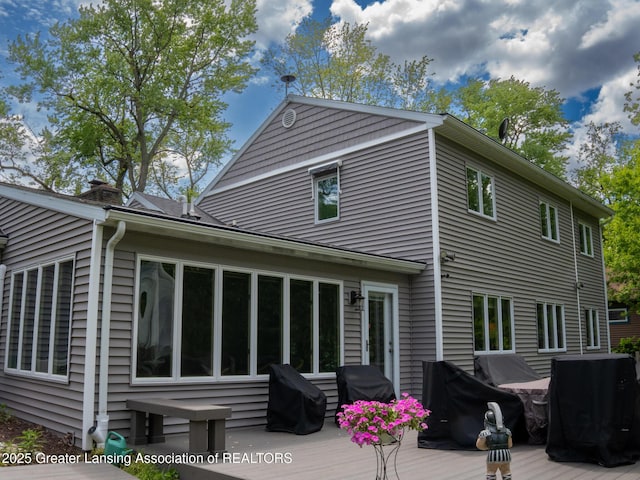 1561 Roseland Ave, East Lansing, MI 48823 - rear view of house featuring a wooden deck and a chimney