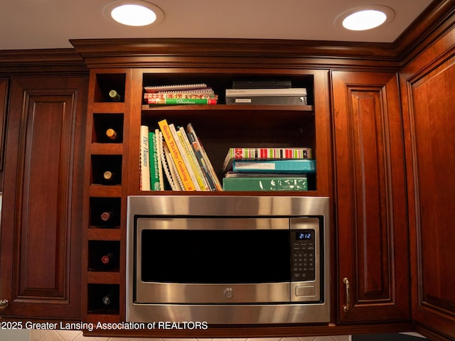 1561 Roseland Ave, East Lansing, MI 48823 - detailed view of stainless steel microwave and crown molding