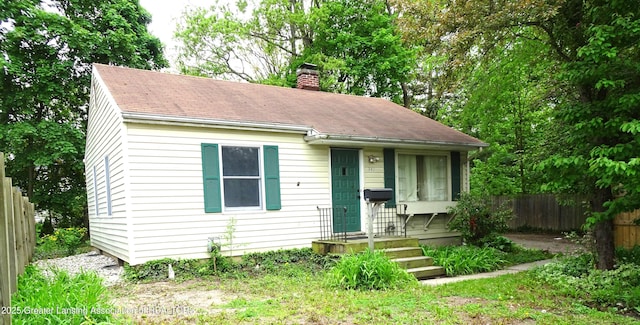 341 W Saginaw St, East Lansing, MI 48823 - bungalow-style house with a chimney and a shingled roof