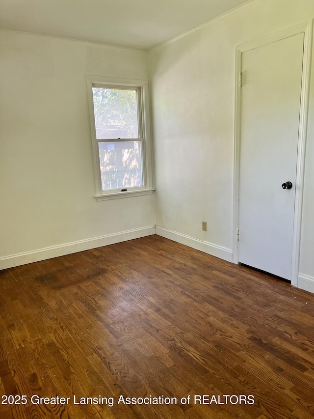 341 W Saginaw St, East Lansing, MI 48823 - spare room featuring dark wood-style floors and baseboards