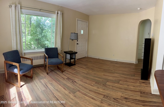 341 W Saginaw St, East Lansing, MI 48823 - sitting room with arched walkways, wood finished floors, and healthy amount of natural light