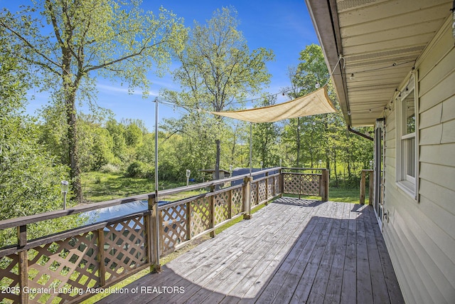 7319 E 5th Point Highway, Eaton Rapids, MI 48827 - wooden deck featuring view of wooded area