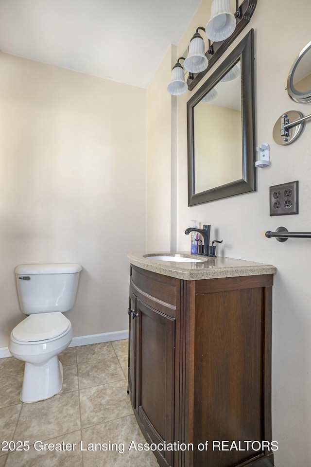 7319 E 5th Point Highway, Eaton Rapids, MI 48827 - bathroom featuring baseboards, vanity, toilet, and tile patterned floors