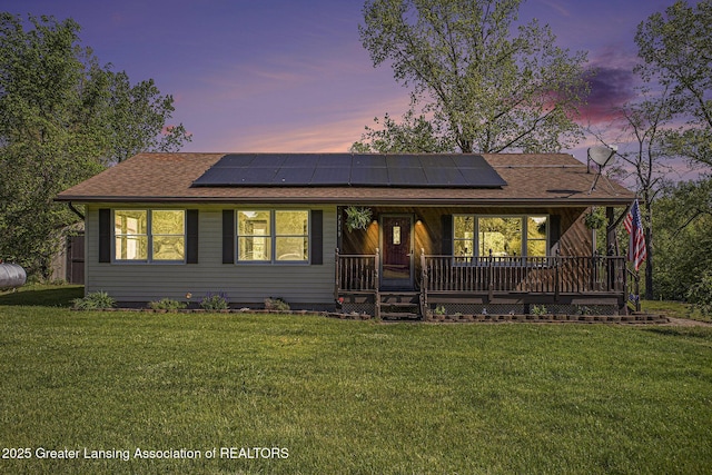 7319 E 5th Point Highway, Eaton Rapids, MI 48827 - ranch-style home featuring solar panels, a shingled roof, and a front yard