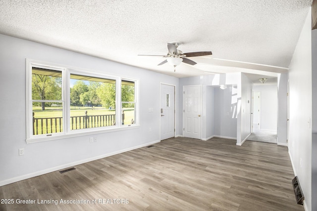 7319 E 5th Point Highway, Eaton Rapids, MI 48827 - foyer entrance with a textured ceiling, a ceiling fan, wood finished floors, and baseboards