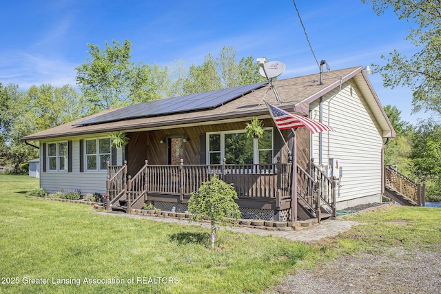 7319 E 5th Point Highway, Eaton Rapids, MI 48827 - ranch-style home featuring solar panels, stairs, a front yard, and a porch