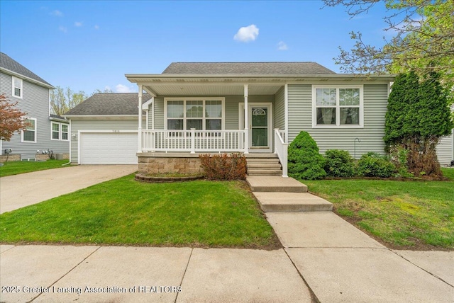 3816 Kiskadee Dr, East Lansing, MI 48823 - bungalow with covered porch, a front lawn, driveway, and a garage