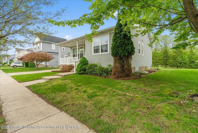 3816 Kiskadee Dr, East Lansing, MI 48823 - view of front of home featuring a front yard and a porch