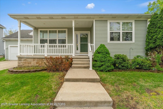 3816 Kiskadee Dr, East Lansing, MI 48823 - view of front of house featuring covered porch, a front yard, an attached garage, and concrete driveway