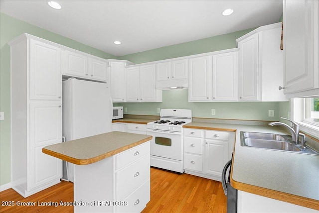 3816 Kiskadee Dr, East Lansing, MI 48823 - kitchen with white appliances, a sink, light wood-type flooring, white cabinetry, and recessed lighting