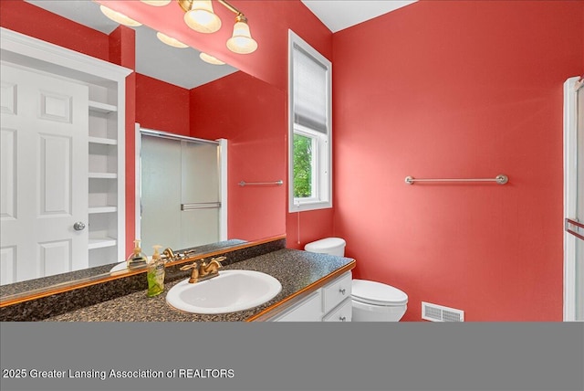 3816 Kiskadee Dr, East Lansing, MI 48823 - full bathroom featuring vanity, a shower with door, and toilet