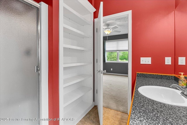 3816 Kiskadee Dr, East Lansing, MI 48823 - bathroom with a sink, a ceiling fan, a shower stall, and tile patterned floors
