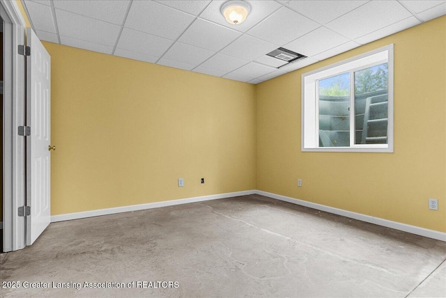 3816 Kiskadee Dr, East Lansing, MI 48823 - spare room featuring concrete floors, baseboards, and a paneled ceiling