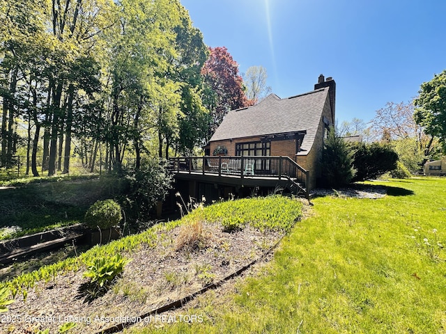 812 Dryer Farm Rd, Lansing, MI 48917 - back of house with a deck, a lawn, and a chimney