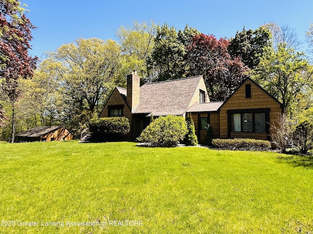 812 Dryer Farm Rd, Lansing, MI 48917 - view of front of property with a front yard, a chimney, and roof with shingles