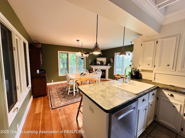 812 Dryer Farm Rd, Lansing, MI 48917 - kitchen with dishwasher, a sink, white cabinetry, and plenty of natural light