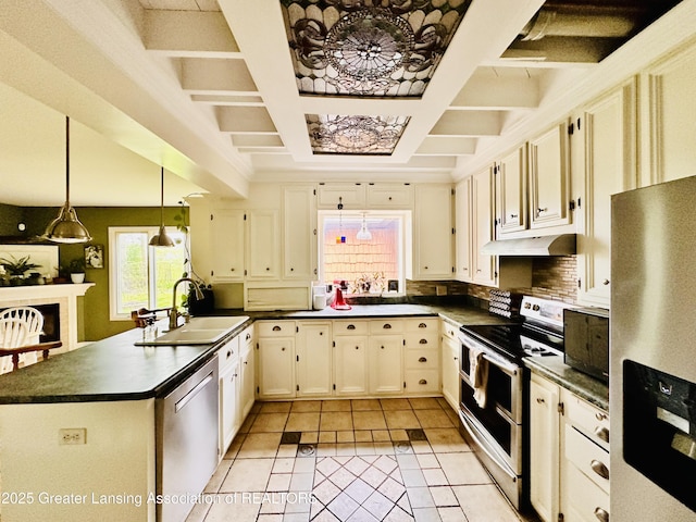 812 Dryer Farm Rd, Lansing, MI 48917 - kitchen featuring stainless steel appliances, a sink, dark countertops, under cabinet range hood, and coffered ceiling