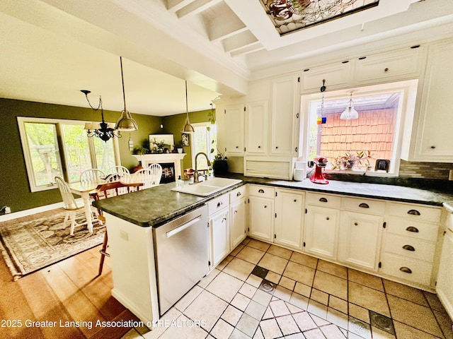812 Dryer Farm Rd, Lansing, MI 48917 - kitchen with dishwasher, a sink, dark countertops, a peninsula, and white cabinets