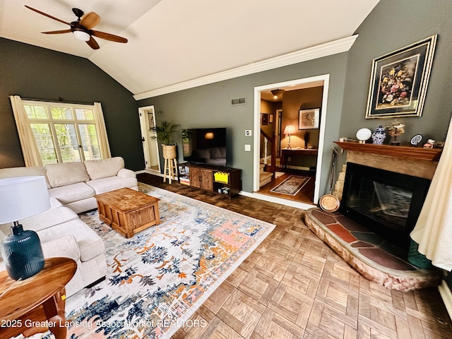 812 Dryer Farm Rd, Lansing, MI 48917 - living area featuring ceiling fan, vaulted ceiling, crown molding, a glass covered fireplace, and baseboards
