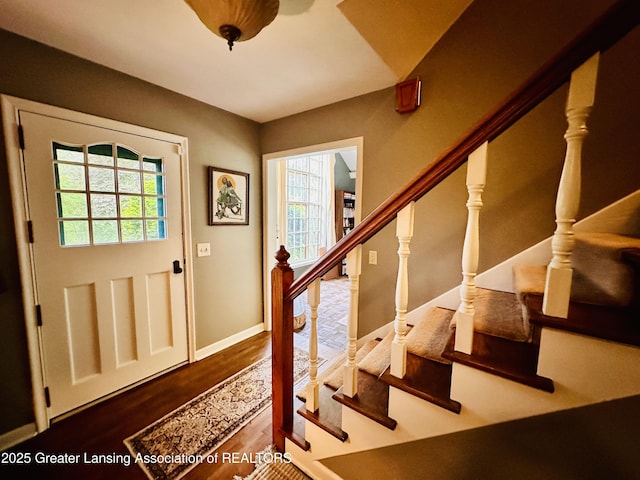 812 Dryer Farm Rd, Lansing, MI 48917 - foyer with plenty of natural light, stairway, wood finished floors, and baseboards