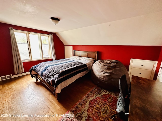 812 Dryer Farm Rd, Lansing, MI 48917 - bedroom featuring wood-type flooring and vaulted ceiling