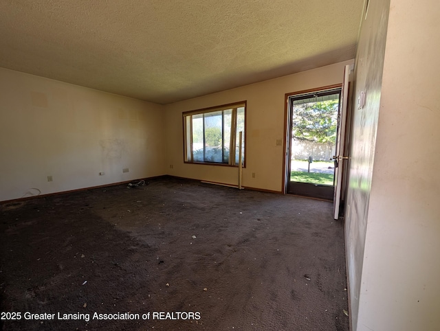 5650 Hughes Rd, Lansing, MI 48911 - unfurnished room with a textured ceiling, baseboards, and carpet