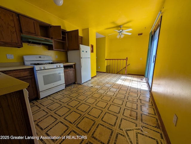 5650 Hughes Rd, Lansing, MI 48911 - kitchen with white appliances, under cabinet range hood, open shelves, light countertops, and ceiling fan