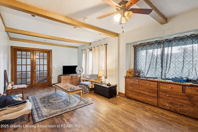 912 Pacific Ave, Lansing, MI 48910 - living area with beamed ceiling, french doors, wood finished floors, a ceiling fan, and baseboards