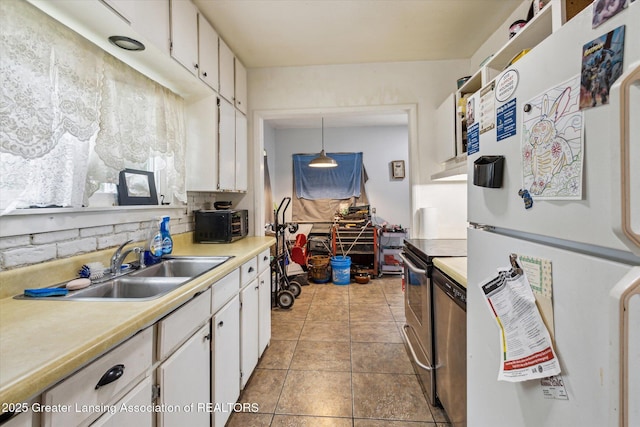 912 Pacific Ave, Lansing, MI 48910 - kitchen featuring freestanding refrigerator, stainless steel range with electric stovetop, a sink, white cabinetry, and light countertops