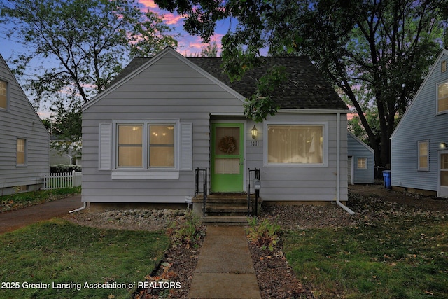 1411 Poxson Ave, Lansing, MI 48910 - bungalow-style house with entry steps and roof with shingles
