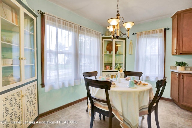 1411 Poxson Ave, Lansing, MI 48910 - dining room with a chandelier, baseboards, and light tile patterned floors