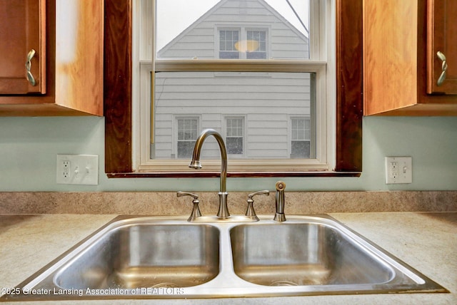 1411 Poxson Ave, Lansing, MI 48910 - kitchen view of a sink, light countertops, and brown cabinets