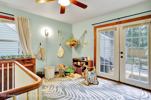 1411 Poxson Ave, Lansing, MI 48910 - recreation room featuring french doors, ceiling fan, healthy amount of natural light, and wood finished floors