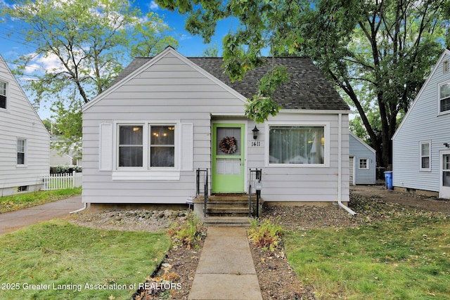 1411 Poxson Ave, Lansing, MI 48910 - bungalow-style home with roof with shingles and entry steps