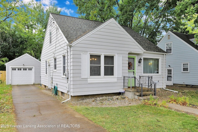 1411 Poxson Ave, Lansing, MI 48910 - bungalow-style house with an outdoor structure, a shingled roof, a detached garage, driveway, and a front lawn