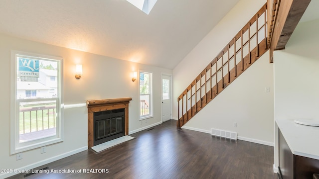 4918 Westhaven Blvd, Lansing, MI 48917 - unfurnished living room with lofted ceiling, dark wood-style floors, a fireplace with flush hearth, stairs, and baseboards