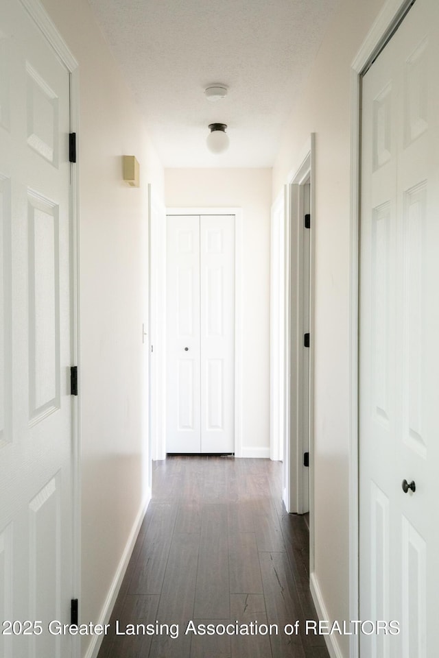 4918 Westhaven Blvd, Lansing, MI 48917 - hall with baseboards and dark wood-style floors