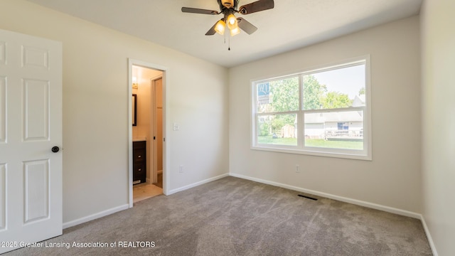 4918 Westhaven Blvd, Lansing, MI 48917 - unfurnished bedroom featuring carpet floors, baseboards, and ensuite bath