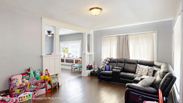 1023 Bement St, Lansing, MI 48912 - living room with ornate columns, wood-type flooring, and ceiling fan