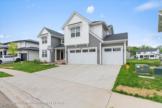 5651 Copper Creek Dr, Haslett, MI 48840 - view of front of house featuring concrete driveway, a front yard, a garage, board and batten siding, and central air condition unit
