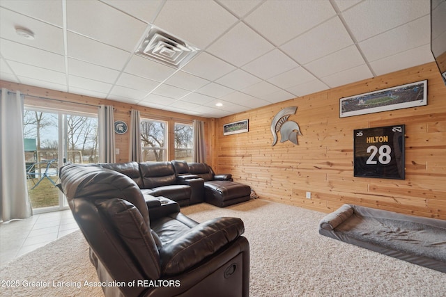 9671 Lakeside Dr, Perrinton, MI 48871 - carpeted living area featuring wood walls, plenty of natural light, tile patterned floors, and a paneled ceiling