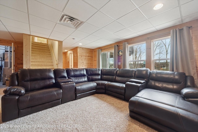 9671 Lakeside Dr, Perrinton, MI 48871 - carpeted living area with wooden walls, stairway, and a drop ceiling
