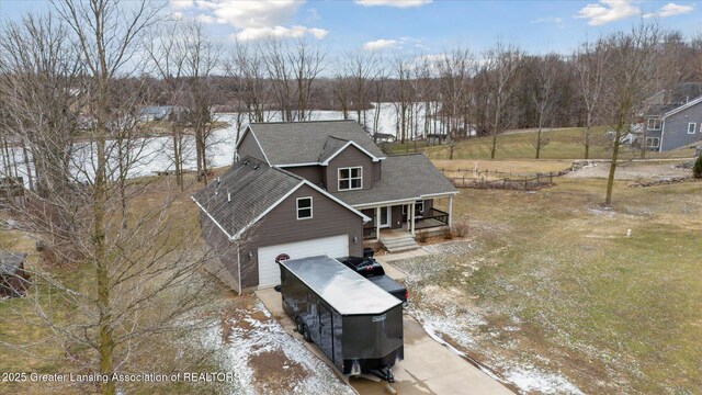 9671 Lakeside Dr, Perrinton, MI 48871 - view of front of property featuring a porch, a garage, concrete driveway, and roof with shingles