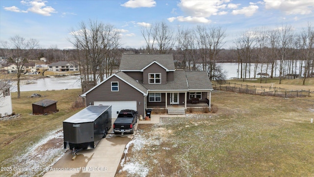 9671 Lakeside Dr, Perrinton, MI 48871 - traditional-style house with covered porch, concrete driveway, a water view, a garage, and roof with shingles