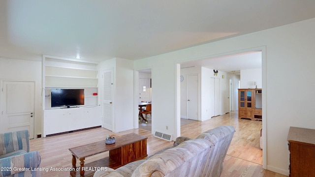 5120 Wardcliff Dr, East Lansing, MI 48823 - living area with light wood-style floors and built in features
