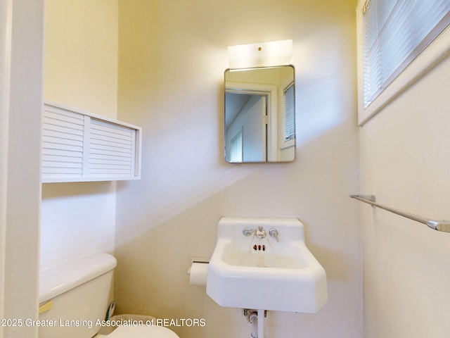 5120 Wardcliff Dr, East Lansing, MI 48823 - half bathroom featuring toilet and a sink