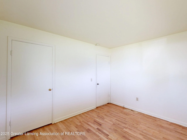 5120 Wardcliff Dr, East Lansing, MI 48823 - unfurnished bedroom with light wood-type flooring and baseboards